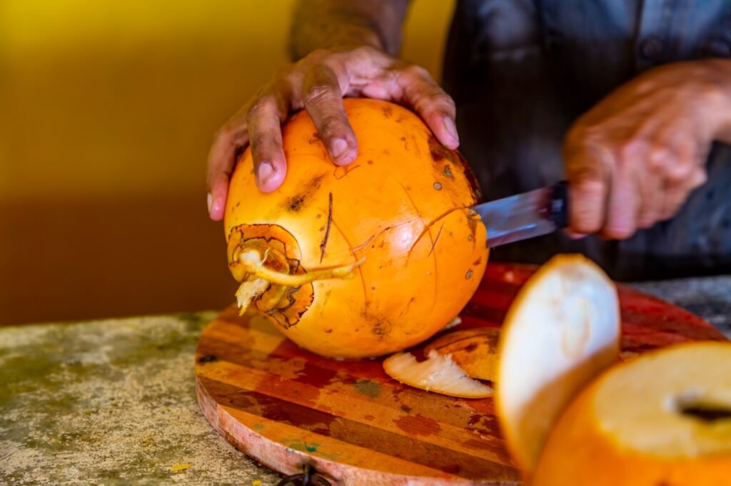 Preparing of a coconut for drinking on a Hikkaduwa market at Sri Lanka